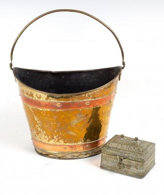 An oval brass bucket with copper