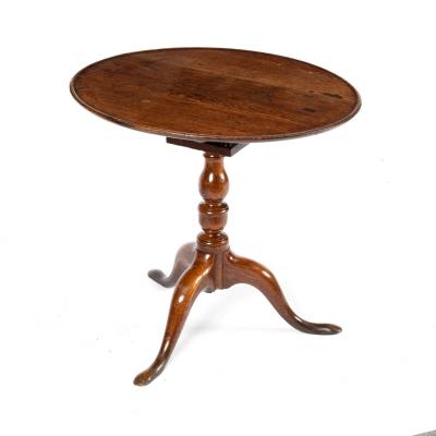 A circular oak table on a turned 36d9da