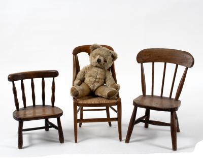 Three childrens chairs and a teddy