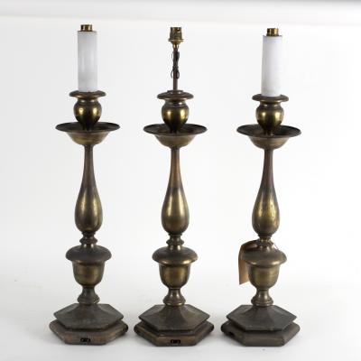 Three silvered metal lamps, circa