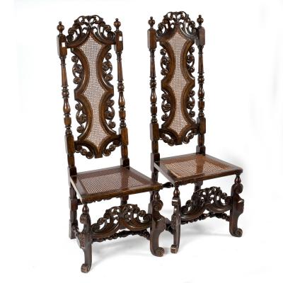 A pair of high back chairs of Carolean