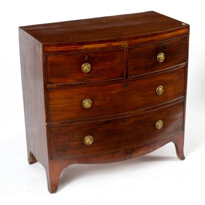 A mahogany bowfront chest of three long