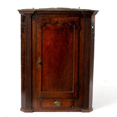 An early 19th Century oak corner cupboard,