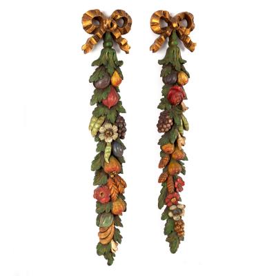 A pair of hanging fruit carvings,