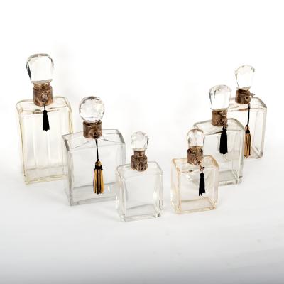Six graduated glass decanters, all with