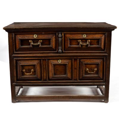 An oak chest of three drawers with