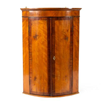 An oak and mahogany corner cupboard