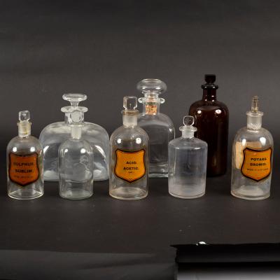 Three apothecaries labelled glass jars,