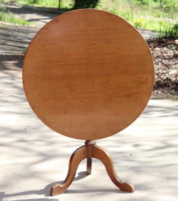 A circular mahogany table on a turned