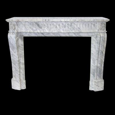 A carved Louis XVI style chimneypiece