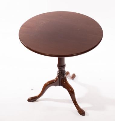 A circular mahogany table on a turned