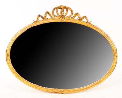 A gilt plaster oval wall mirror