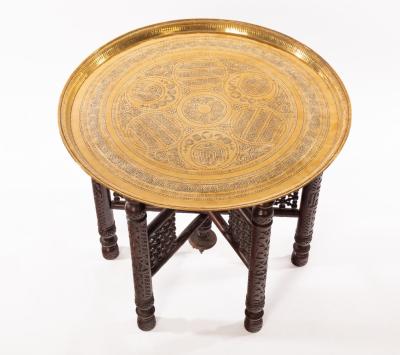 A brass topped Benares table, the