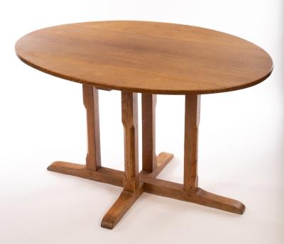 An oval oak table, on square chamfered