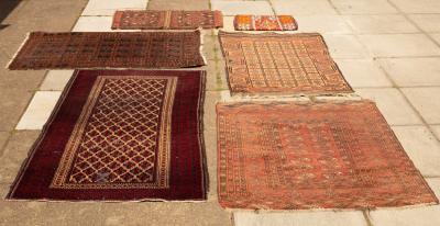 A Bokhara rug on red ground, ivory