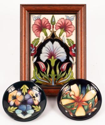 A framed Moorcroft plaque decorated