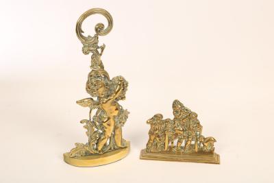 Two brass doorstops, the larger