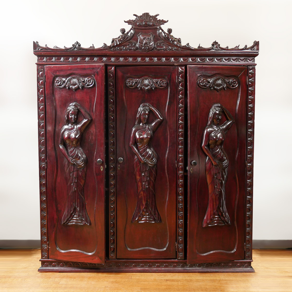 CARVED MAHOGANY THREE DOOR ARMOIRE: