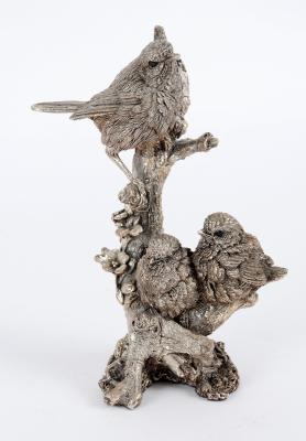 A filled silver model of three birds