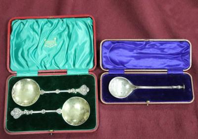 A pair of silver spoons with decorative