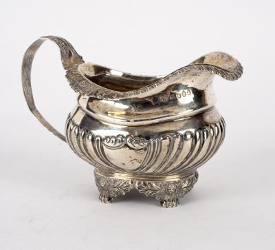 A silver cream jug, WH, London 1820,