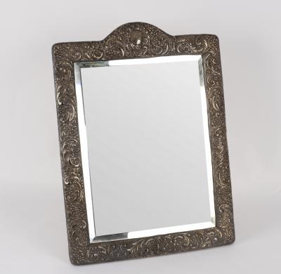 An embossed silver framed mirror,