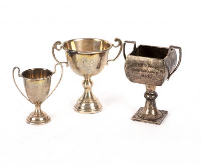 Three small silver trophy cups, approximately