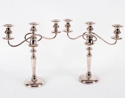 A pair of silver plated two-branch