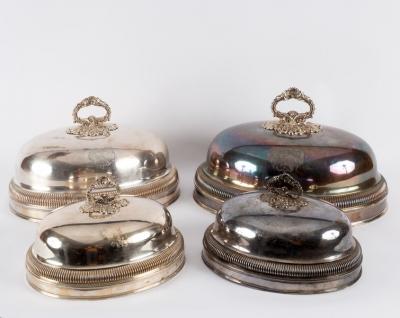 A set of four silver plated food