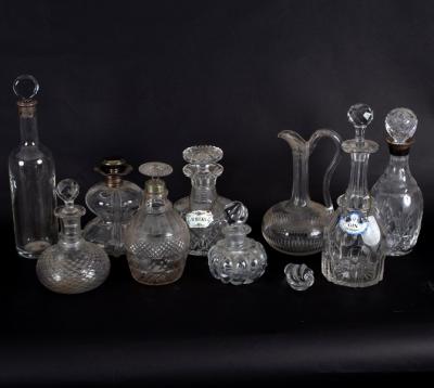 A group of nine glass decanters, four