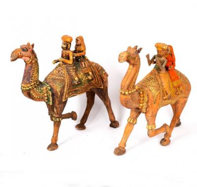 A carved wood camel with ceremonial