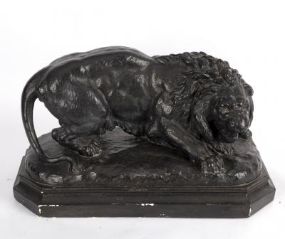 A blacked plaster figure of a lion,