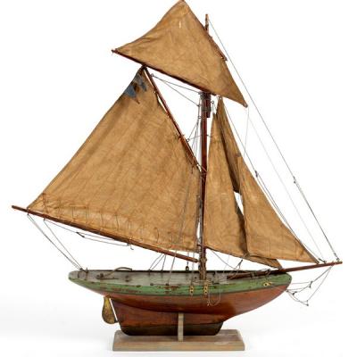 A wooden pond yacht with rigging 36d5f3