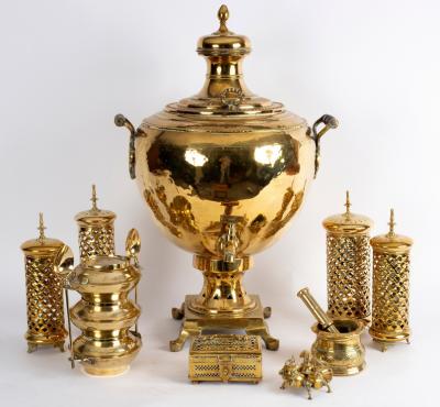 A brass two-handled samovar on a pedestal