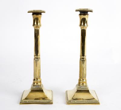 A pair of brass candlesticks, circa