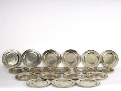 Eighteen polished pewter plates, 28cm