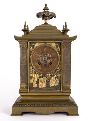 A gilt brass and metal mantel clock