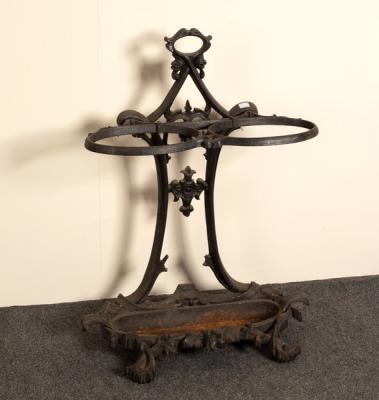 A cast iron umbrella stand with
