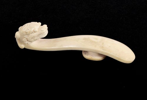 A CARVED IVORY BELT HOOKA CARVED