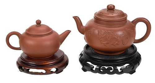 TWO MINIATURE LIDDED CLAY TEAPOTS WITH