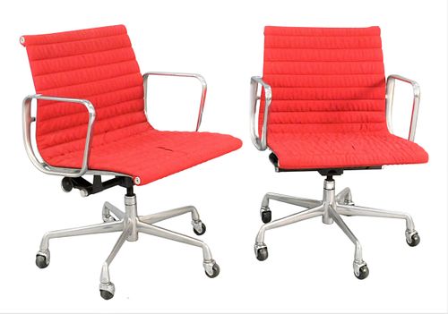 TWO RED EAMES ALUMINUM GROUP CHAIRSTwo