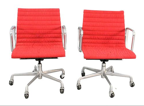 TWO RED EAMES ALUMINUM GROUP CHAIRSTwo