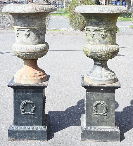 PAIR OF IRON URNS ON SQUARE PEDESTALS,