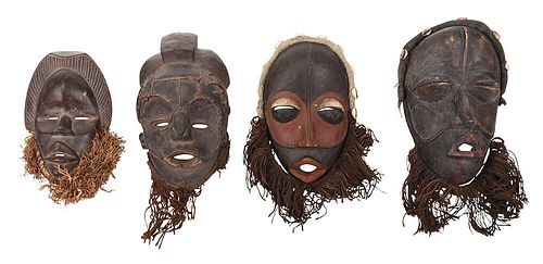 FOUR WEST AFRICAN CARVED WOOD AND