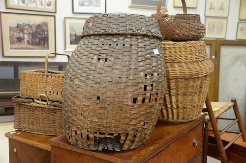 GROUP OF ELEVEN WOVEN BASKETS TALLEST