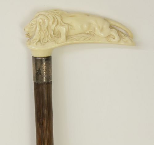 CARVED STALKING LION HANDLED CANE  37d4a4