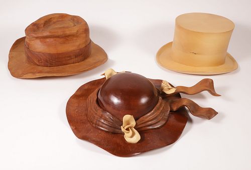 THREE CARVED WOOD HATS, 20TH CENTURYThree