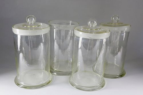 4 BLOWN CLEAR GLASS STORAGE CANISTERS,