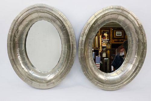 TWO RIVETED SILVER GILT OVAL MIRRORSTwo