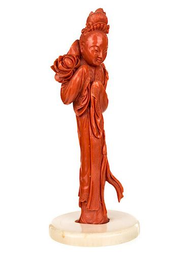 A CHINESE CARVED RED CORAL FIGURE